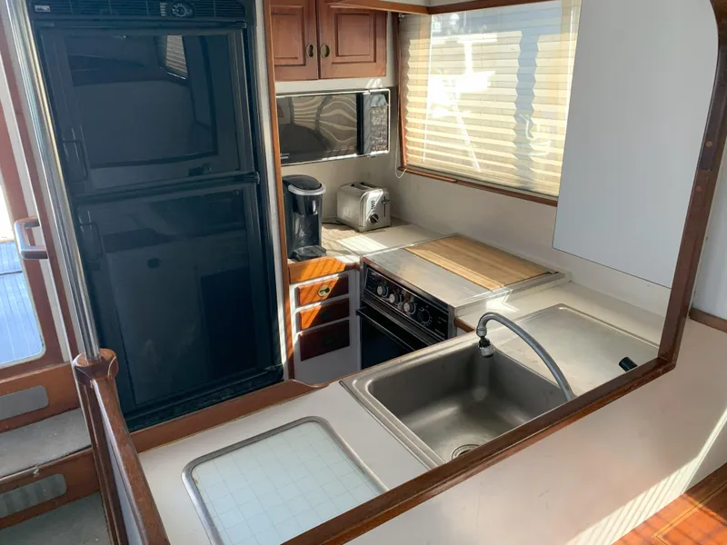 Slide: The Image of Compact kitchen area in a 1986 Gladding Hearn Hunt Designed 60 boat. - 42