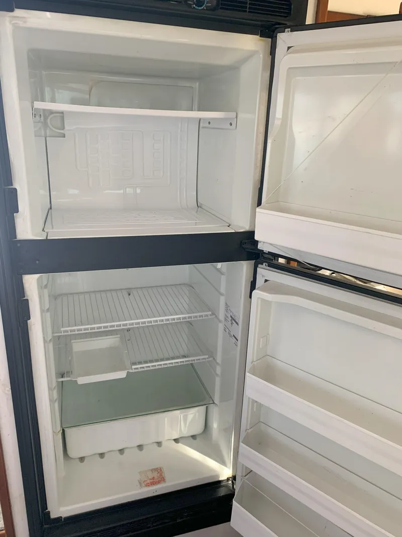 Slide: The Image of Empty refrigerator and freezer in a 1986 Gladding Hearn Hunt Designed 60 boat. - 47