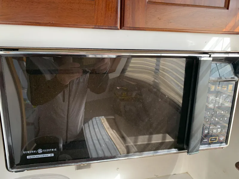 Slide: The Image of General Electric microwave in a 1986 Gladding Hearn Hunt Designed 60 boat kitchen. - 48