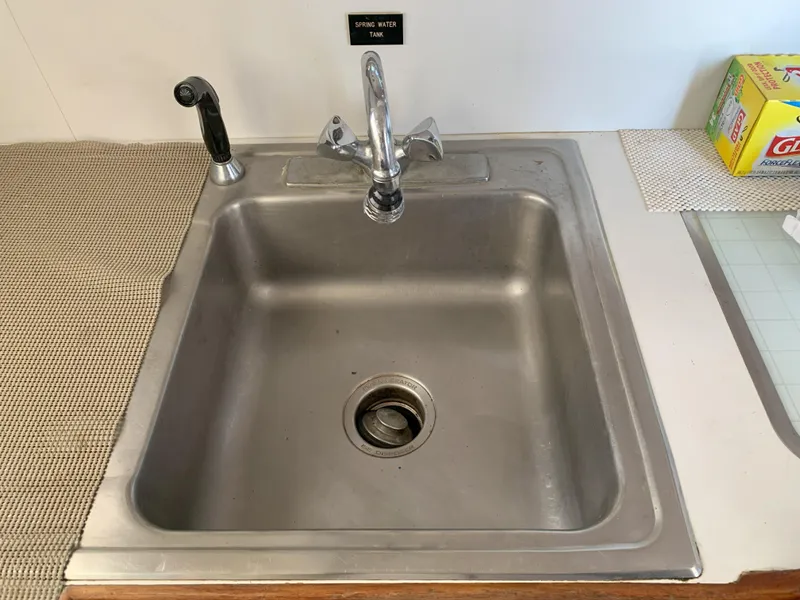 Slide: The Image of Stainless steel sink with faucet and sprayer in a 1986 Gladding Hearn Hunt Designed 60. - 49