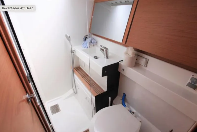 Slide: The Image of 2018 Jeanneau Sun Odyssey 440 bathroom with modern fixtures and wooden accents. - 11