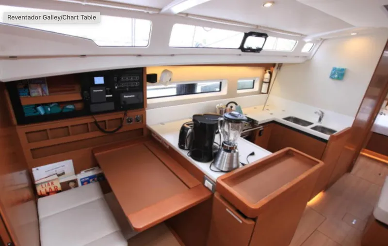 Slide: The Image of Jeanneau Sun Odyssey 440 galley, 2018 model, featuring modern kitchen appliances and sleek wood finishes. - 16