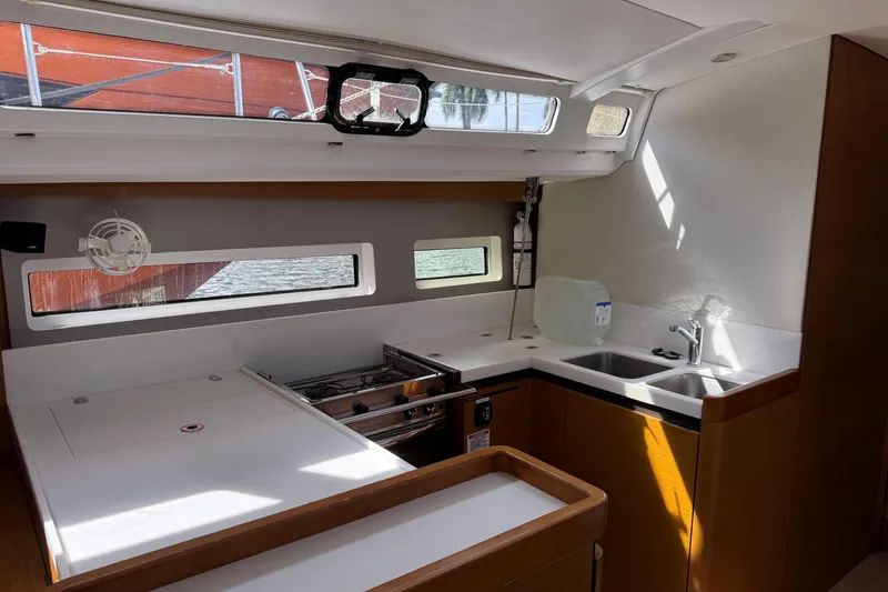 Slide: The Image of Modern kitchen interior of 2018 Jeanneau Sun Odyssey 440 yacht, featuring sleek design and ample lighting. - 24