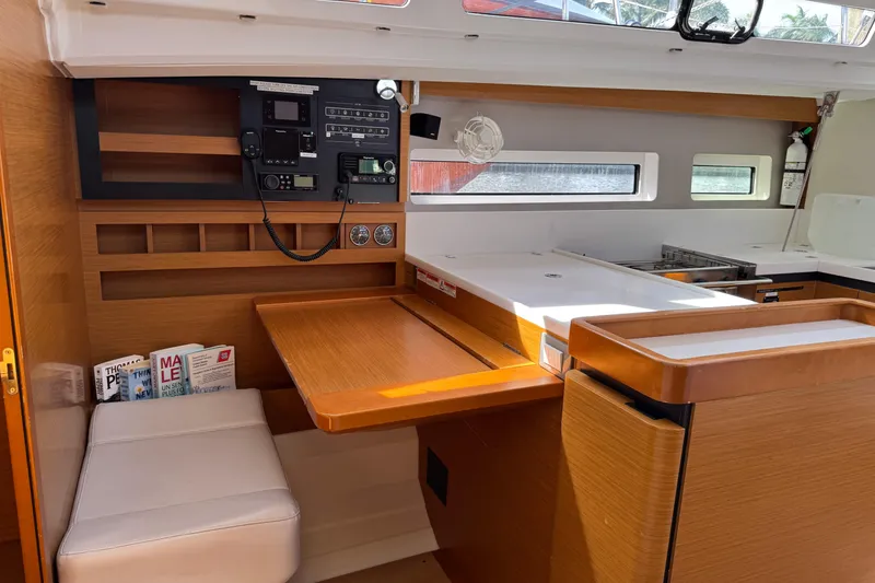 Slide: The Image of Interior of 2018 Jeanneau Sun Odyssey 440 yacht with navigation station and seating area. - 25