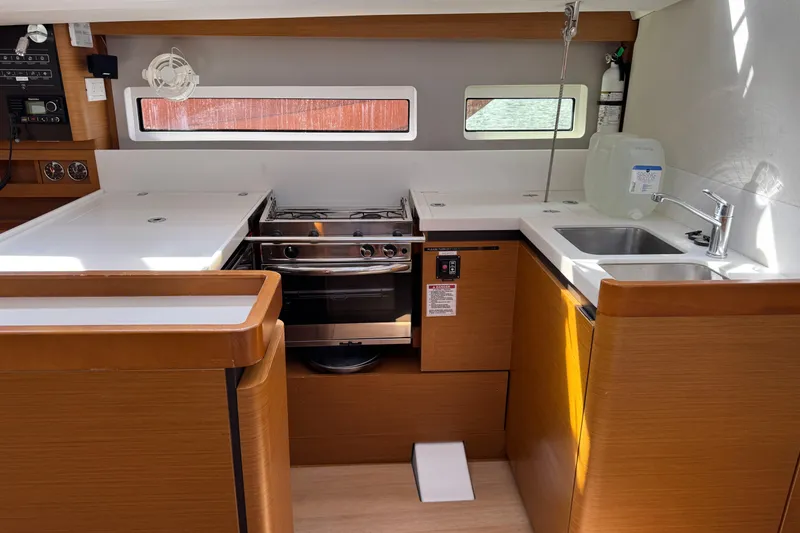 Slide: The Image of Modern kitchen interior of 2018 Jeanneau Sun Odyssey 440 yacht, featuring stove and sink. - 27