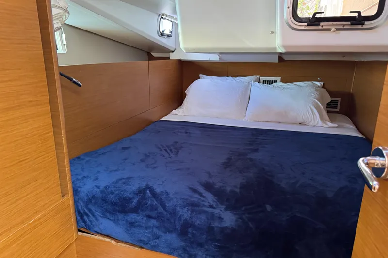 Slide: The Image of Cozy cabin interior of 2018 Jeanneau Sun Odyssey 440 with plush bedding. - 28