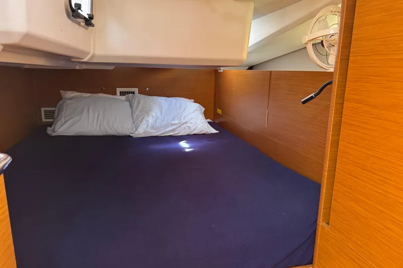 Slide: The Image of Cozy cabin interior of 2018 Jeanneau Sun Odyssey 440 sailboat with pillows and blue bedding. - 29