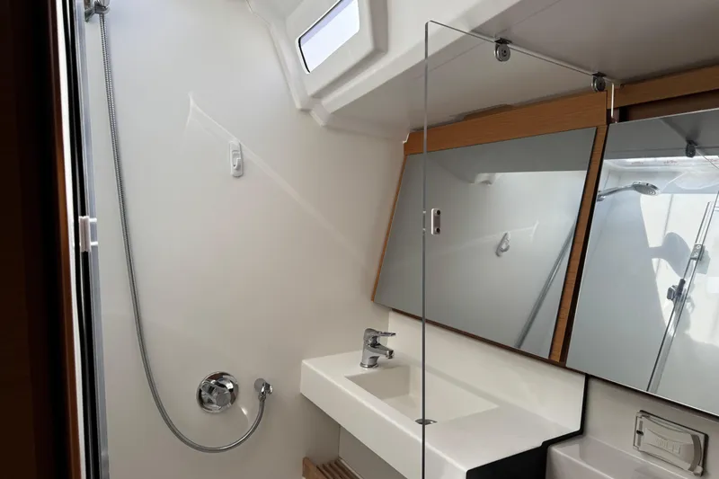 Slide: The Image of Modern bathroom in 2018 Jeanneau Sun Odyssey 440 yacht with sleek fixtures and mirrors. - 33
