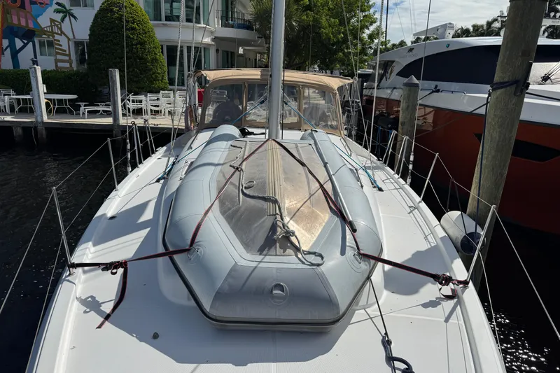 Slide: The Image of 2018 Jeanneau Sun Odyssey 440 yacht docked, featuring inflatable dinghy on deck. - 5