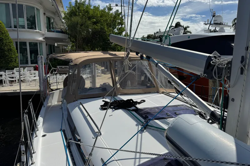 Slide: The Image of 2018 Jeanneau Sun Odyssey 440 sailboat docked, featuring a sleek design and spacious deck. - 6