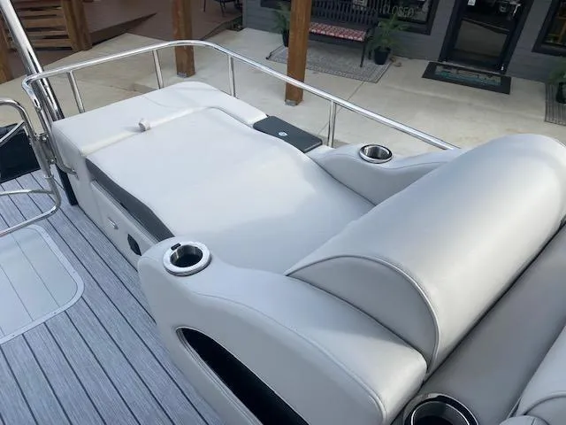 Slide: The Image of 2024 SunCatcher Elite 324 SS boat with luxurious seating and cup holders. - 12