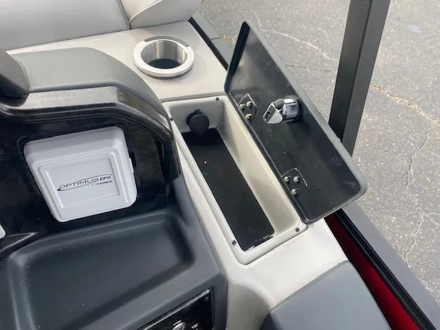 Slide: The Image of SunCatcher Elite 324 SS 2024 boat console with storage compartment and cup holder. - 13