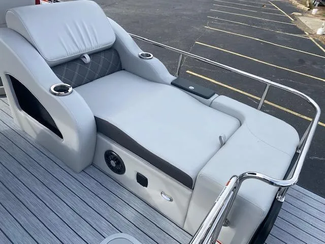 Slide: The Image of 2024 SunCatcher Elite 324 SS boat lounge seating with cup holders and speaker. - 16