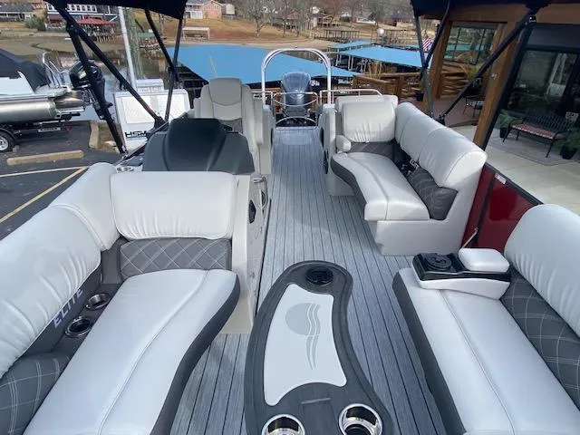 Slide: The Image of 2024 SunCatcher Elite 324 SS pontoon boat interior with luxurious seating and modern design. - 19