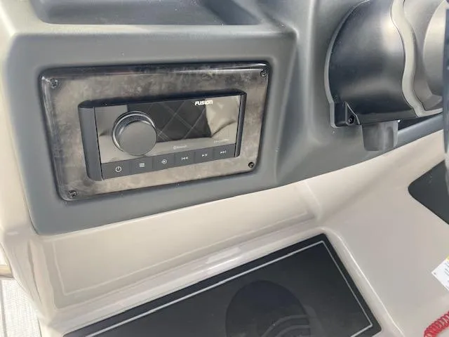 Slide: The Image of 2024 SunCatcher Elite 324 SS boat dashboard with Fusion stereo system. - 25