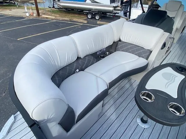 Slide: The Image of 2024 SunCatcher Elite 324 SS boat with luxurious seating and cup holders. - 26