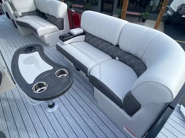 Slide: The Image of 2024 SunCatcher Elite 324 SS boat interior with luxurious seating and cup holders. - 27