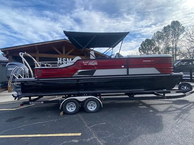 Slide: The Image of 2024 SunCatcher Elite 324 SS pontoon boat on a trailer, parked outdoors. - 4