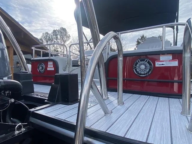 Slide: The Image of 2024 SunCatcher Elite 324 SS boat deck with stainless steel railings and speakers. - 7