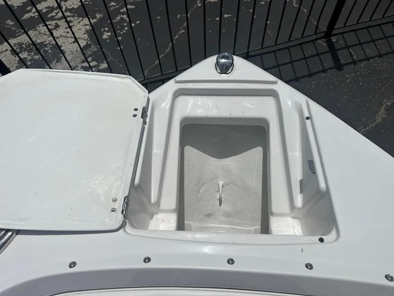 Slide: The Image of 2024 Monterey 224 FS boat bow storage compartment, open lid, white finish. - 11