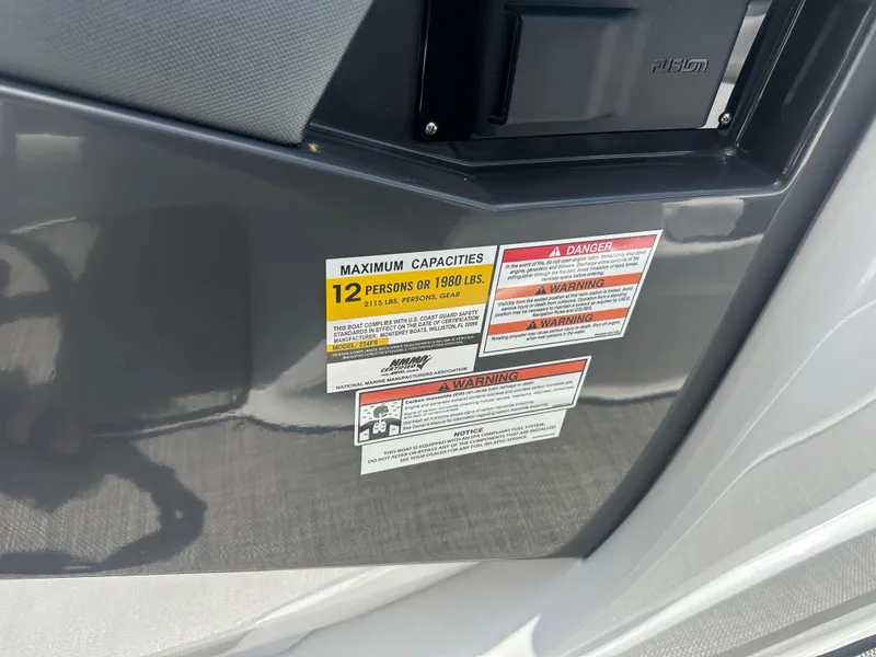 Slide: The Image of Capacity warning labels on 2024 Monterey 224 FS boat, maximum 12 persons or 1980 lbs. - 18
