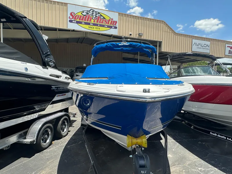Slide: The Image of 2024 Monterey 224 FS boat with blue cover at South Austin dealership. - 2