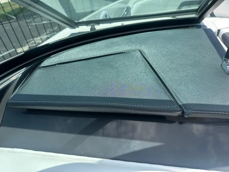 Slide: The Image of 2024 Monterey 224 FS boat dashboard with sleek black cover. - 21