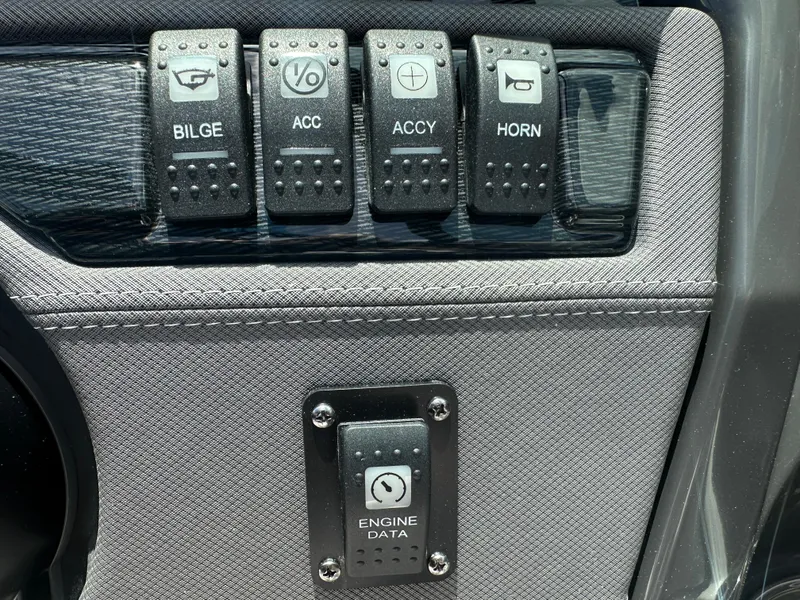 Slide: The Image of Control panel of 2024 Monterey 224 FS boat with switches and engine data display. - 25