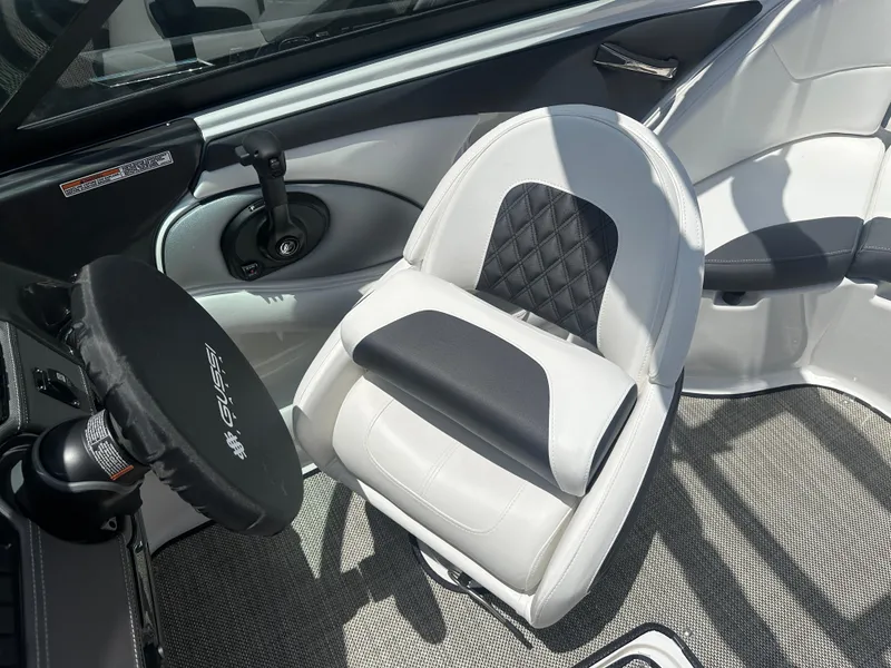 Slide: The Image of 2024 Monterey 224 FS boat interior with stylish seating and steering wheel. - 29