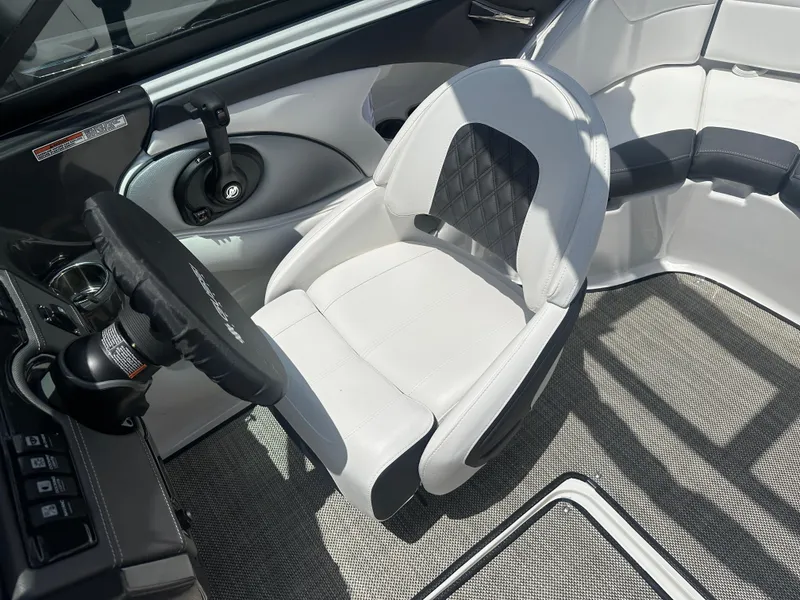 Slide: The Image of 2024 Monterey 224 FS boat interior with modern seating and steering wheel. - 30
