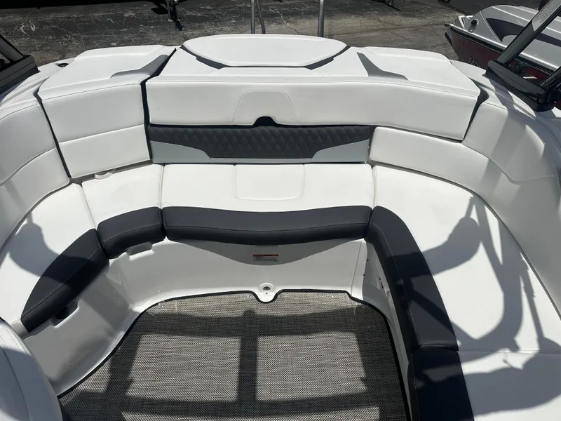 Slide: The Image of 2024 Monterey 224 FS boat interior with white and gray seating. - 31