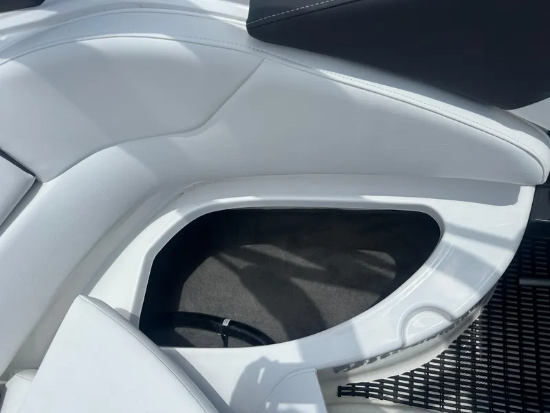 Slide: The Image of 2024 Monterey 224 FS boat interior with white seating and storage compartment. - 37