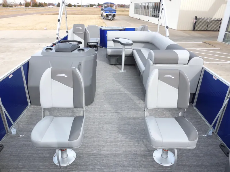Slide: The Image of 2024 Bennington 22 SVF pontoon boat interior with gray seating and helm. - 4