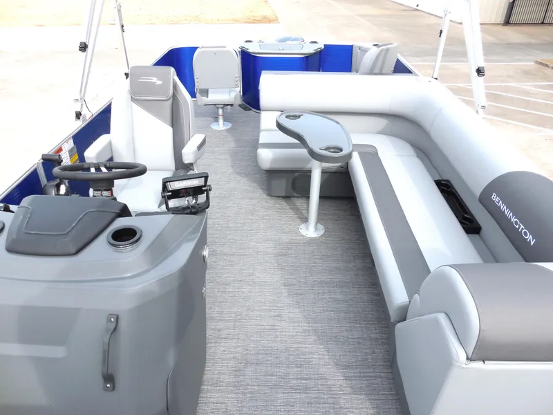 Slide: The Image of 2024 Bennington 22 SVF pontoon boat interior with gray seating and steering console. - 5