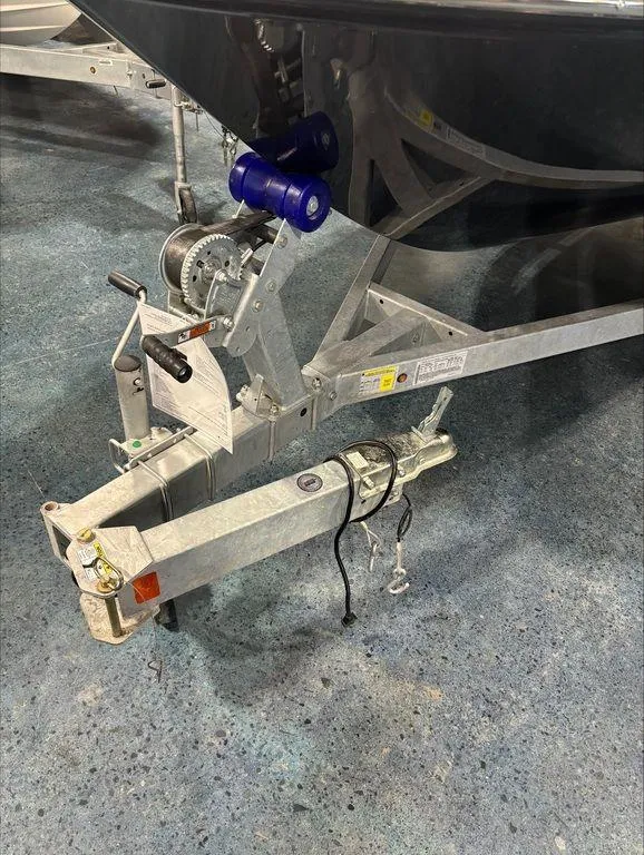Slide: The Image of Trailer hitch of a 2024 Bayliner M17 boat on a blue concrete floor. - 5