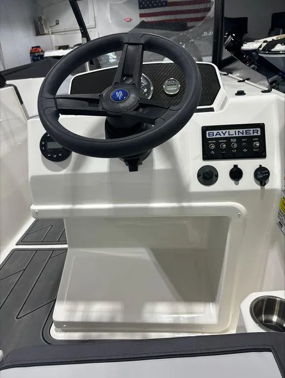 Slide: The Image of 2024 Bayliner M17 boat dashboard with steering wheel and control panel. - 6