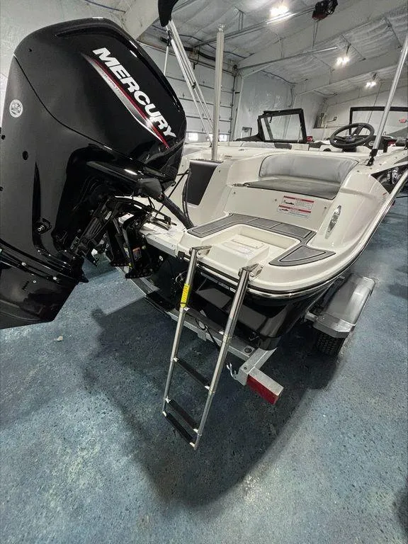 Slide: The Image of 2024 Bayliner M17 boat with Mercury outboard motor and swim ladder in showroom. - 8