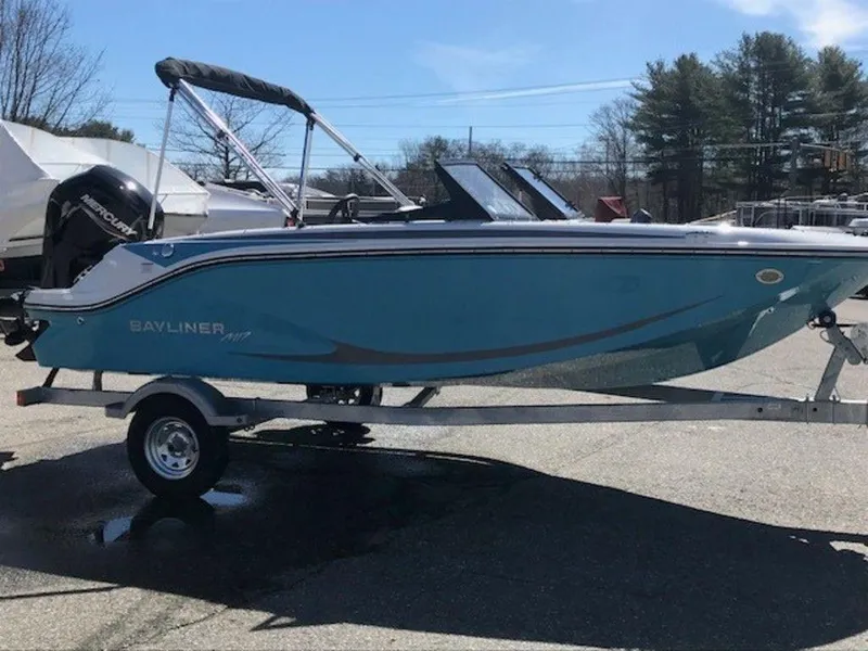 Slide: The Image of 2024 Bayliner M17 boat on a trailer, blue hull, outboard motor, and bimini top. - 15