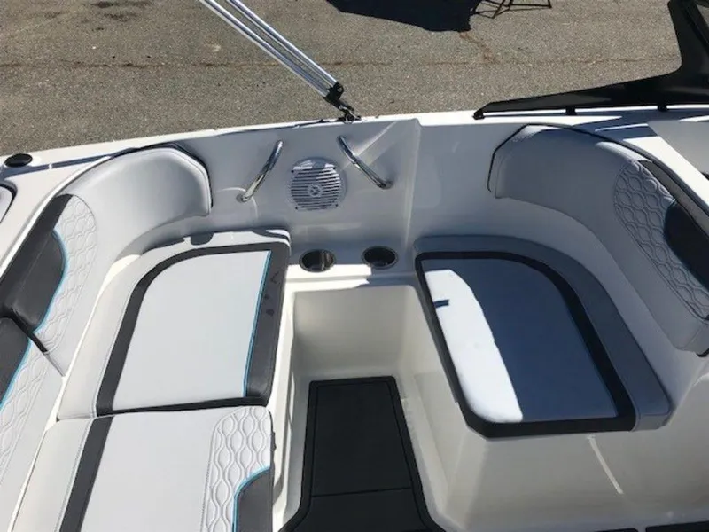 Slide: The Image of 2024 Bayliner M17 boat interior with cushioned seating and cup holders. - 4