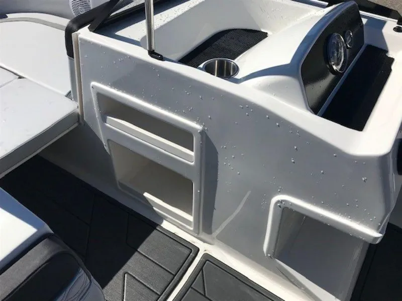Slide: The Image of 2024 Bayliner M17 boat interior with storage compartments and cup holder. - 5