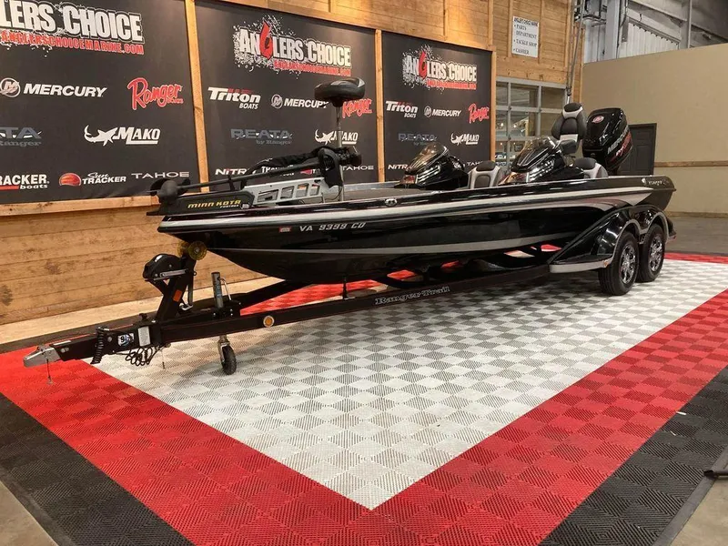 Slide: The Image of 2014 Ranger Z521C bass boat on display in showroom with branded backdrop. - 4