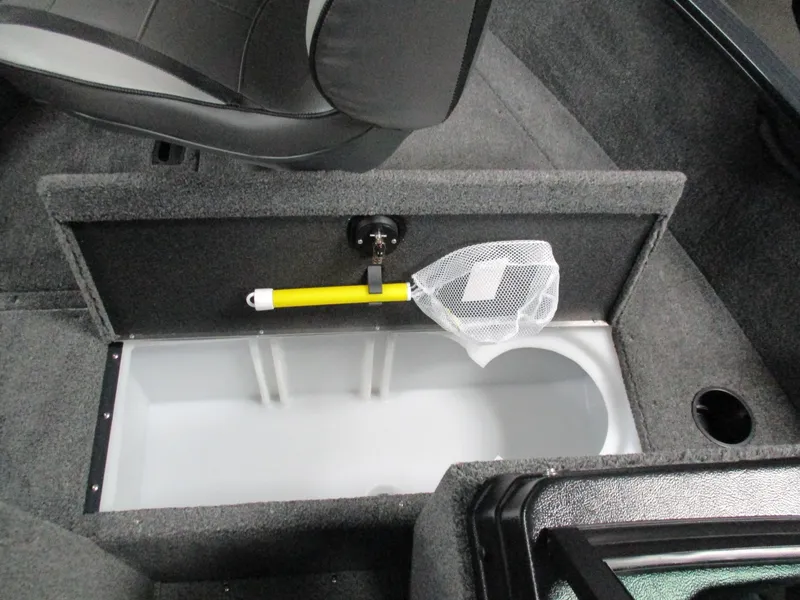 Slide: The Image of 2024 Lund 1650 Rebel XL Sport boat storage compartment with a fishing net. - 5