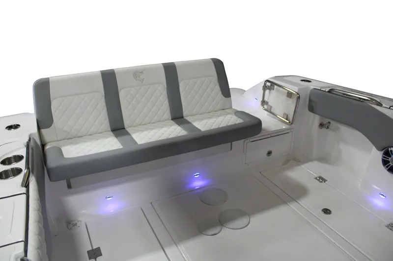 Slide: The Image of 2025 Marlago 35SS boat interior with cushioned seating and ambient lighting. - 4