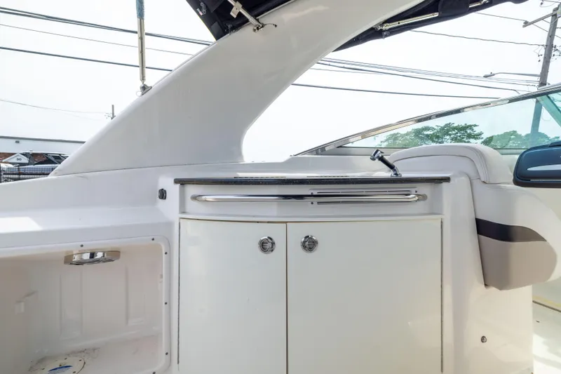 Slide: The Image of 2015 Chaparral 287 SSX boat interior with sleek cabinetry and seating. - 12