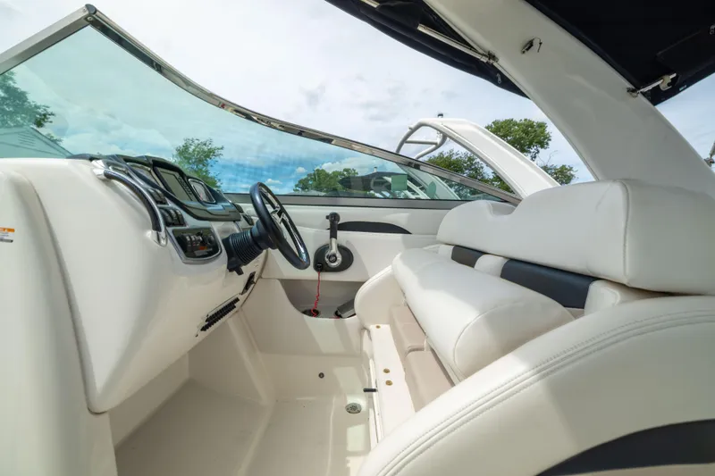 Slide: The Image of Interior view of 2015 Chaparral 287 SSX boat with white seating and modern dashboard. - 14