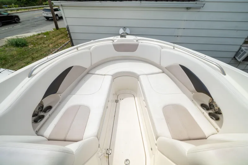 Slide: The Image of 2015 Chaparral 287 SSX boat interior with white seating and cup holders. - 15