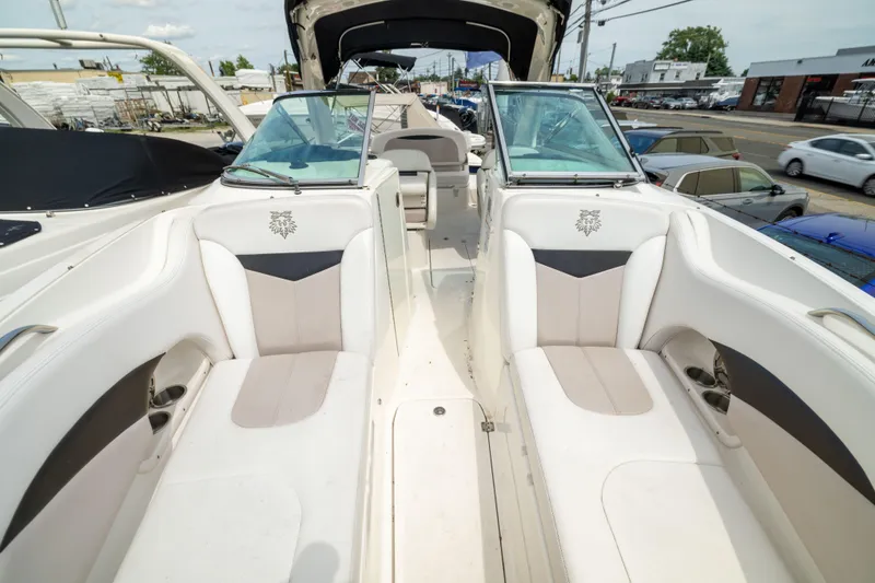 Slide: The Image of 2015 Chaparral 287 SSX boat interior with white seating and open deck layout. - 16