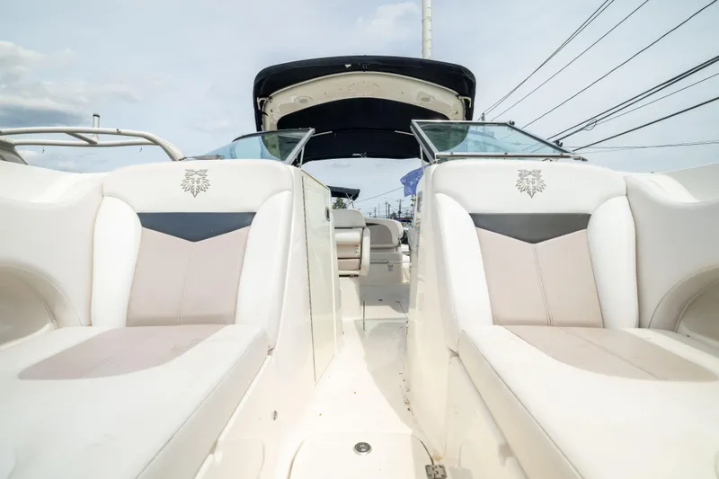 Slide: The Image of 2015 Chaparral 287 SSX boat interior with white seating and open cockpit view. - 17