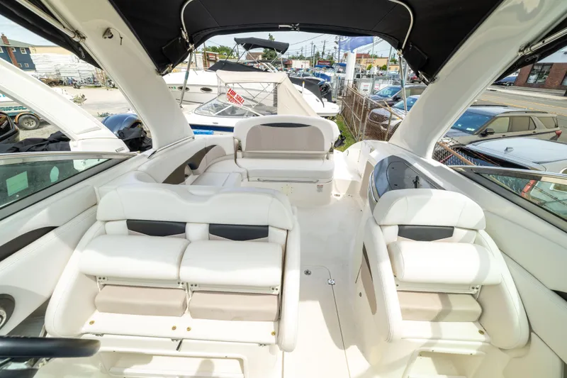 Slide: The Image of 2015 Chaparral 287 SSX boat interior with white seating and canopy. - 18