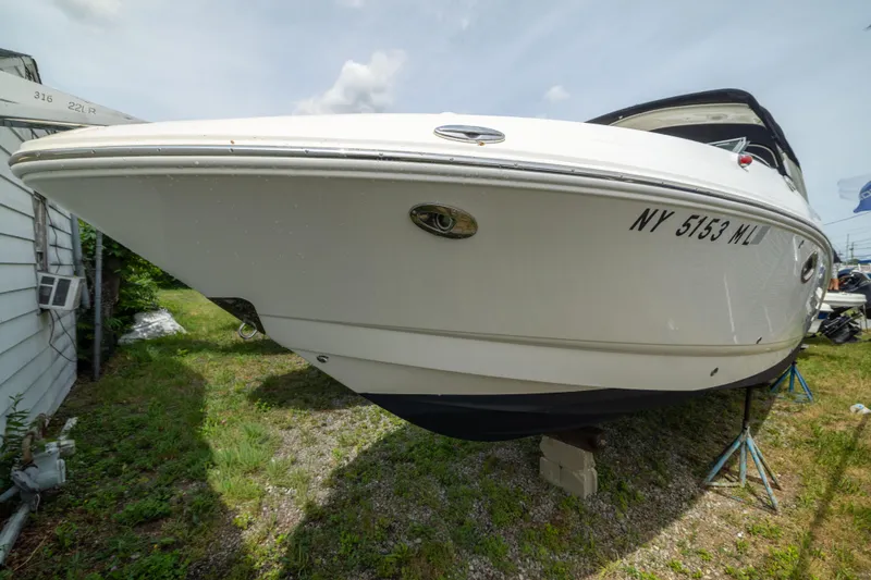 Slide: The Image of 2015 Chaparral 287 SSX boat on stands, side view with registration number visible. - 2
